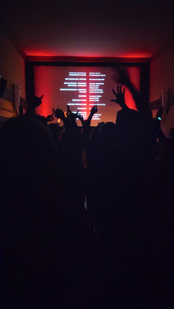 Hands raised in front of the end credits